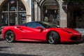 Profile view of red ferrari parked in the street