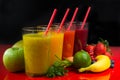 Colofrul fresh pressed fruit juices in tall glasses with fruits