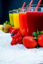 Colofrul fresh pressed fruit juices in tall glasses with fruits