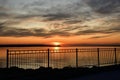 Coloful sunset view, St-Lawrence river, pier handrail, Leclercville, Quebec