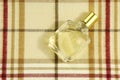 Cologne bottle on check pattern Royalty Free Stock Photo