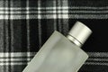 Cologne bottle on check pattern Royalty Free Stock Photo