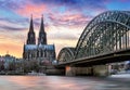 Cologne Cathedral and Hohenzollern Bridge at sunset - night Royalty Free Stock Photo