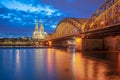 Cologne Cathedral at night with Hohenzollern Bridge landmark in Cologne city, Germany Royalty Free Stock Photo