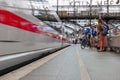 Cologne central railway station with blur background of motion of High speed train and group of passengers in Cologne, Germany.