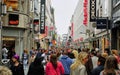 Diverse crowd fills the main shopping district street in Cologne, Germany