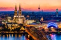 Beautiful night landscape of the gothic Cologne cathedral, Hohenzollern Bridge and the River Rhine at sunset and blue hour in Royalty Free Stock Photo