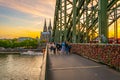 COLOGNE, GERMANY, AUGUST 11, 2018: People are passing on Hohenzollern bridge over Rhein during sunset, Germany Royalty Free Stock Photo