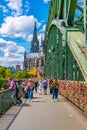 COLOGNE, GERMANY, AUGUST 11, 2018: People are passing on Hohenzollern bridge over Rhein during sunset, Germany Royalty Free Stock Photo