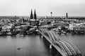 Black and white panoramic aerial landscape of the gothic catholic Cologne cathedral, Hohenzollern Bridge and the River Rhine in