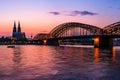 Evening silhouette skyline landscape of the gothic Cologne Cathedra, Hohenzollern railway and pedestrian bridge, the old town and Royalty Free Stock Photo