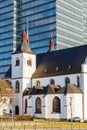 Alt St. Heribert in Cologne-Deutz, Germany, in front of an office tower