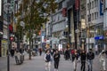 COLOGNE, GERMANY - NOVEMBER 5, 2022: crowd of people walking on schildergasse street with stores and german kids walking. Royalty Free Stock Photo