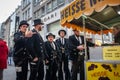 COLOGNE, GERMANY - NOVEMBER 11, 2022: group of young german men dressed with chimney sweeps costumes for Cologne Carnival buying