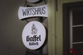 COLOGNE, GERMANY - NOVEMBER 12, 2022: Selective blur on a Gaffel Kolsch Beer logo on a local retailer. Gaffel is a Kolsch beer, a