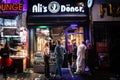 COLOGNE, GERMANY - NOVEMBER 11, 2022: Selective blur on youngsters with Cologne Carnival costume in a kebab fast food restaurant