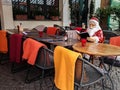 Cologne / Germany - 2018: Santa Claus reading the menu on a terrace outside of a riverfront cafe in Cologne. Festive holiday mood
