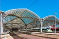 Cologne Koln, Germany: Cologne Central Railway Station Historical Nineteenth Century Architecture against Blue Sky with Train