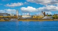 Beautiful rhine river waterfront skyline cityscape, ferris wheel, ancient buildings, flufy cumulus summer clouds