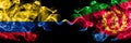 Colombia, Colombian vs Eritrea, Eritrean smoky mystic flags placed side by side. Thick colored silky abstract smokes flags