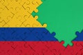 Colombia flag is depicted on a completed jigsaw puzzle with free green copy space on the right side