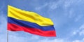 Colombia flag on flagpole on blue sky background. Colombian flag waving in the wind on a background of sky with clouds. Place for Royalty Free Stock Photo