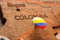 Colombia flag on the pin with red thread showed the paths on the wooden map.