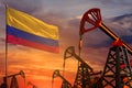 Colombia oil industry concept. Industrial illustration - Colombia flag and oil wells with the red and blue sunset or sunrise sky