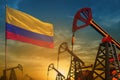 Colombia oil industry concept. Industrial illustration - Colombia flag and oil wells against the blue and yellow sunset sky