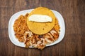 Traditional Colombian breakfast - Grilled chicken, arepa, cheese, fried egg and reheated beans with rice