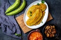 COLOMBIAN CARIBBEAN CENTRAL AMERICAN FOOD. Patacon or toston, fried and flattened whole green plantain banana on white Royalty Free Stock Photo