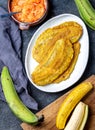 COLOMBIAN CARIBBEAN CENTRAL AMERICAN FOOD. Patacon or toston, fried and flattened whole green plantain banana on white Royalty Free Stock Photo