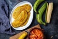 COLOMBIAN CARIBBEAN CENTRAL AMERICAN FOOD. Patacon or toston, fried and flattened whole green plantain banana on white Royalty Free Stock Photo