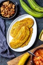 COLOMBIAN CARIBBEAN CENTRAL AMERICAN FOOD. Patacon or toston, fried and flattened whole green plantain banana on white Royalty Free Stock Photo