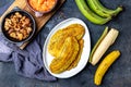 COLOMBIAN CARIBBEAN CENTRAL AMERICAN FOOD. Patacon or toston, fried and flattened whole green plantain banana on white Royalty Free Stock Photo