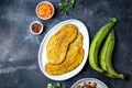 COLOMBIAN CARIBBEAN CENTRAL AMERICAN FOOD. Patacon or toston, fried and flattened whole green plantain banana on white Royalty Free Stock Photo