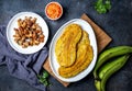 COLOMBIAN CARIBBEAN CENTRAL AMERICAN FOOD. Patacon or toston, fried and flattened whole green plantain banana on white Royalty Free Stock Photo