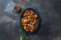 COLOMBIAN CHICHARRON. Fried pork chicharron on black plate. Top view Royalty Free Stock Photo