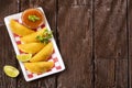 Colombian empanada with spicy sauce. Top view