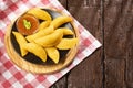 Colombian empanada with spicy sauce on wooden background. Text space