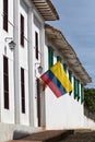 Colombian flag on white colonial building