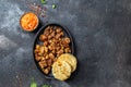 COLOMBIAN FOOD. Fried pork CHICHARRON, AREPAS and colombian tomato sauce. Top view. Black background Royalty Free Stock Photo