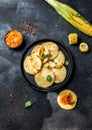 COLOMBIAN FOOD. Maize AREPAS and fried pork chicharron ans colombian tomato sauce. Top view. Black background Royalty Free Stock Photo