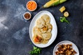 COLOMBIAN FOOD. Maize AREPAS and fried pork chicharron ans colombian tomato sauce. Top view. Black background Royalty Free Stock Photo
