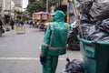 Sanitation worker in uniform with trash