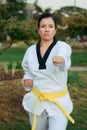 Colombian, Latin American woman practicing taekwondo position attack left fist