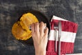 Colombian patacones dish with tomato sauce and onion hogao. Person eating traditional Latin dish. Banished trodden banana Royalty Free Stock Photo