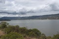 Colombian tomine lake with green mountains grey clouds and sky refflection Royalty Free Stock Photo