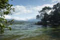 Colombian Tota lake with multicolored water and andean mountains at background.