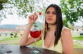 Colombian woman drinking a red cocktail outdoors. Royalty Free Stock Photo